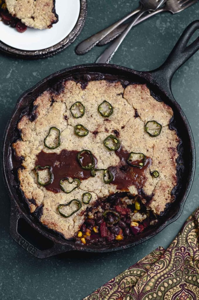 A chili cornbread casserole with a large spoonful taken out