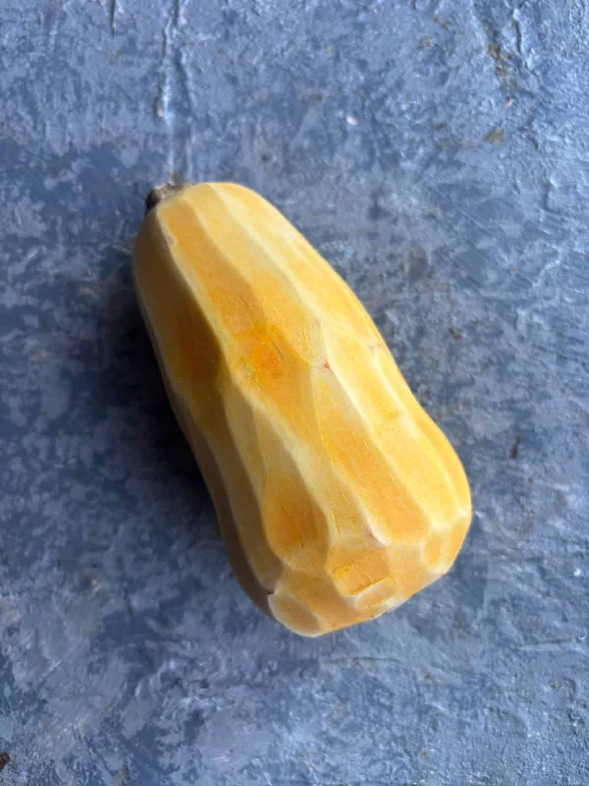 overhead image of a peeled honeynut squash