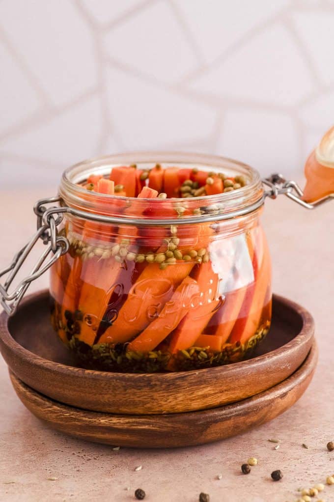 a jar of picked carrot with the lid open