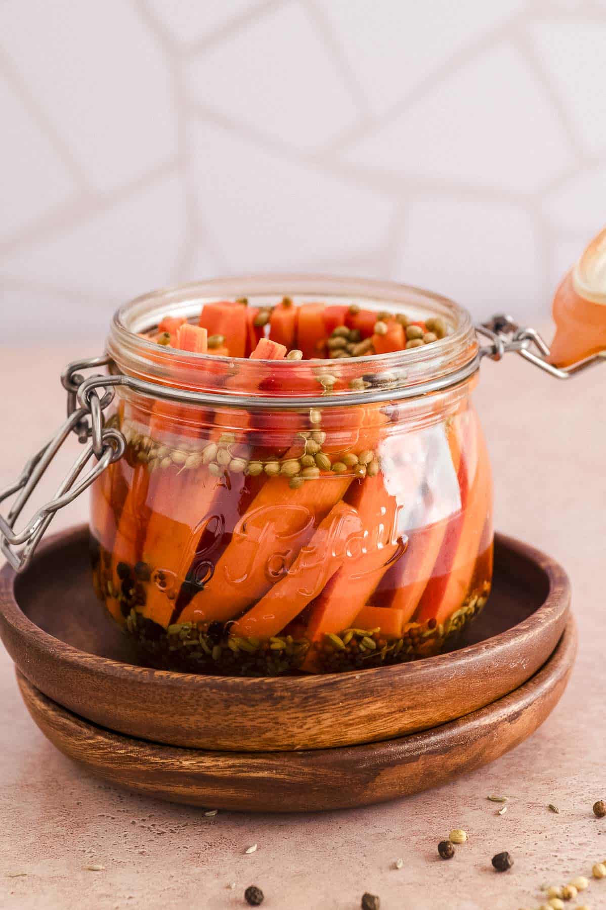 a jar of picked carrot with the lid open